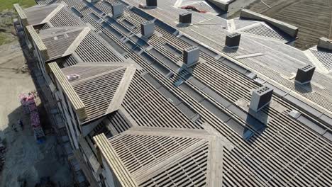 Flying-over-the-wooden-roof-of-an-unfinished-house.-Construction