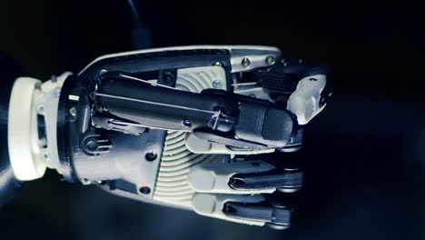 Close-up-of-a-cybernetic-hand-clenching-fingers