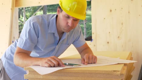 CLOSE-UP:-Construction-site-overseer-shakes-his-head-while-looking-at-plans.