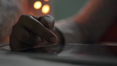 Woman's-hand-scrolling-on-digital-tablet-screen-for-surfing-social-media-on-the-bed-at-night.-Checking-news.