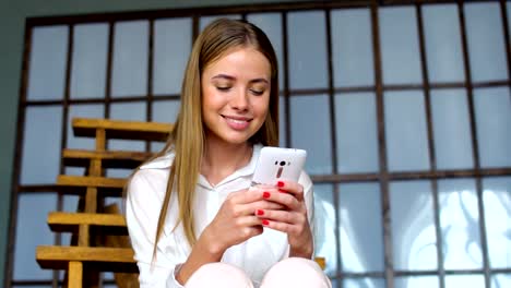 Young-girl-use-cellphone-for-browsing-social-networks-or-messaging-online