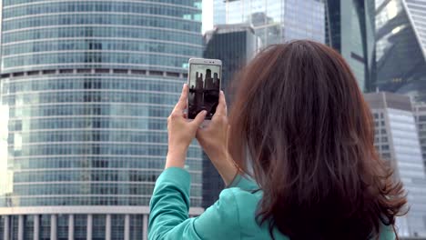 Tourist-photographing-business-center-close-up