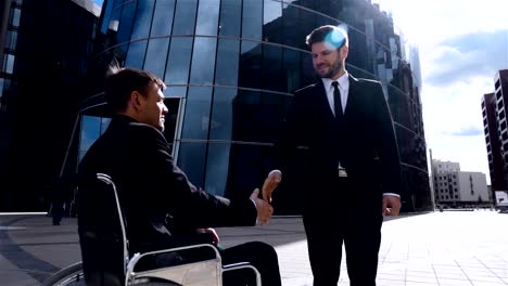 Happy-Entrepreneur-Shaking-Hands-With-Disabled-Businessman-Outdoor