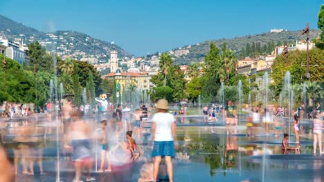 People-walk-on-a-Promenade-du-Paillon-park-timelapse,-famous-with-its-flat-fountains-in-Nice,-France