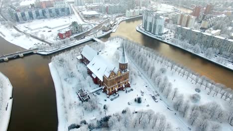 Aerial:-The-Cathedral-in-the-snow-capped-city-of-Kaliningrad,-Russia