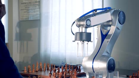 Man-playing-chess-with-innovative-robotic-chess-artificial-intelligence.