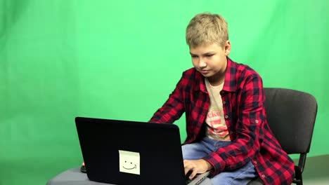 Young-boy-blogger-records-video-on-a-green-background