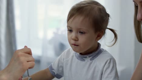 Toddler-Girl-Having-Breakfast-with-Mothers