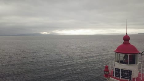 View-from-above-lighthouse-on-sea-coast-on-cloudy-sky-background