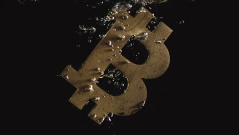 SLOW-MOTION:-Golden-bitcoin-symbol-falls-in-water