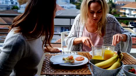 Lesbian-couple-having-food-in-balcony-4k