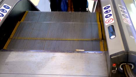 Anonymous-People-Walking-on-the-Escalator-Lift-in-Shopping-Mall