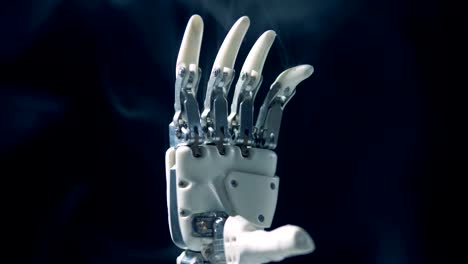 Close-up-of-bionic-hand's-palm-in-smoke