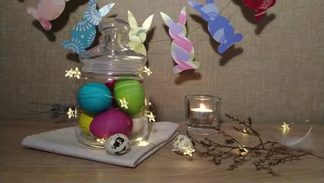 Easter-decoration-burning-candles-falling-feather