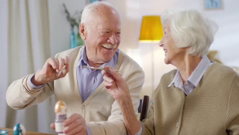 Feliz-pareja-de-ancianos-pintando-huevos