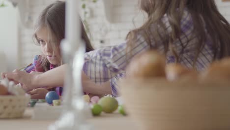 Young-mother-and-her-preteen-daughter-talking-on-the-kitchen.