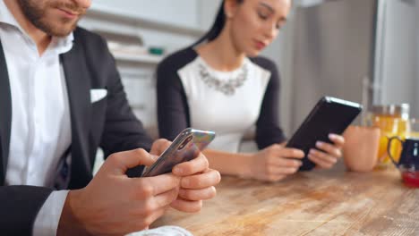 Co-workers-sitting-in-office-kitchen-during-lunch-break