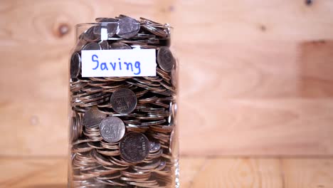 Close-up-save-coin-in-the-bottle-glass