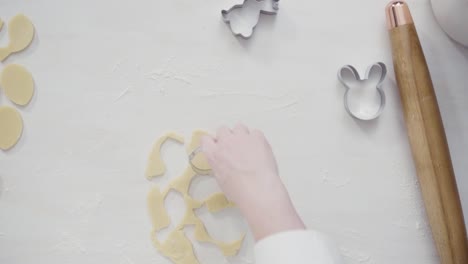 Cutting-sugar-cookie-dough-with-Easter-shaped-cookie-cutters.