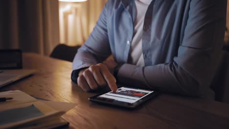 Man-browsing-on-digital-tablet-over-the-desk