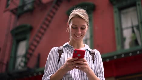 Cheerful-hipster-tourist-enjoying-chatting-with-virtual-friends-during-time-for-recreating-vacations