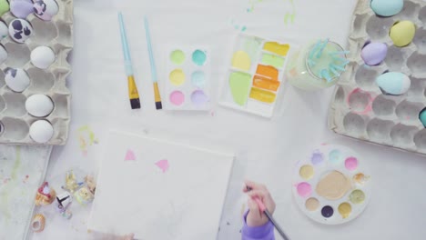 Little-girl-and-her-mom-painting-Easter-art-project-with-acrylic-paint.