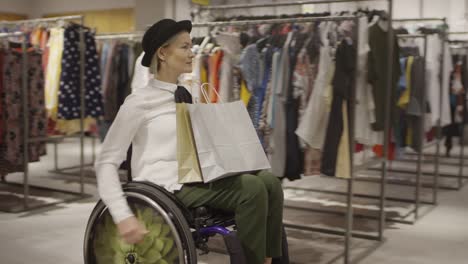 Happy-Young-Woman-in-Wheelchair-Shopping-for-Clothes