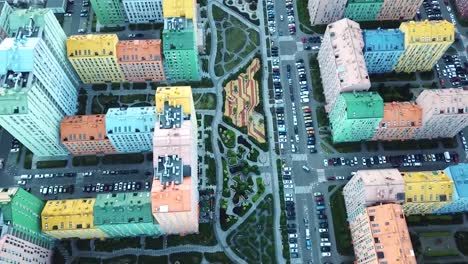 view-from-above-on-a-bright-colorful-district,-colorful-houses-and-roads-filled-with-cars