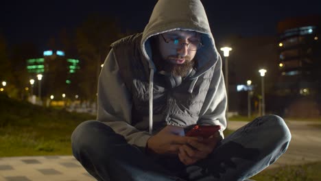 Young-man-with-smart-phone-in-the-park