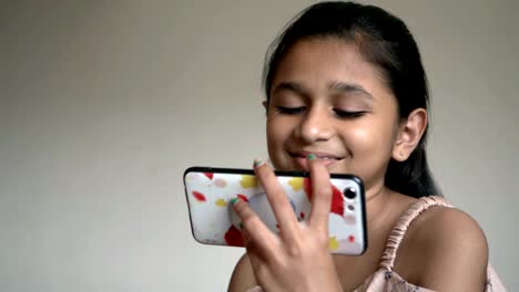 Indian-little-girl-is-Watching-cartoon-on-smartphone