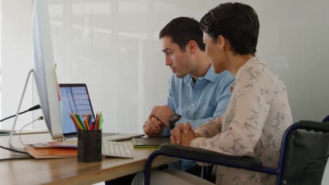 Young-man-and-woman-working-in-a-creative-office