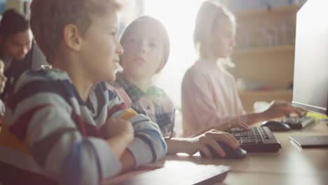 Elementary-School-Computer-Science-Classroom:-Portrait-of-Smart-Girl-and-Boy-Talking-while-using-Personal-Computer,-Learning-Informatics,-Internet-Safety,-Programming-Language-for-Software-Coding