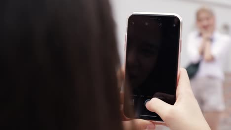 Close-up-Asian-lesbian-couple-using-smartphones-taking-a-photo.-Beautiful-Asian-women-traveling-with-a-friend's-vacation-lifestyle.