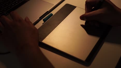 Nahansicht-der-Grafik-Designer-Hand-mit-Grafik-Tablet,-das-über-Nacht-arbeitet