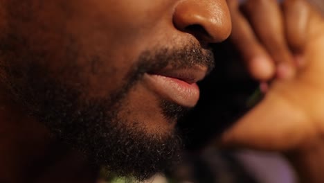 Close-up-African-American-mouth-talks-by-smartphone