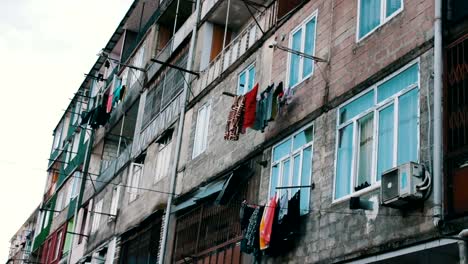 Large-number-of-washed-laundry-hangs-on-a-rope-and-dries-on-the-street-near-the-house