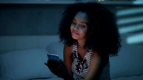 Happy-Latino-Woman-Watching-Video-On-Smartphone