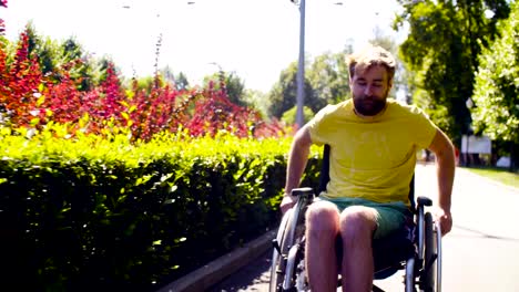 Young-disable-man-in-wheelchair-in-the-park