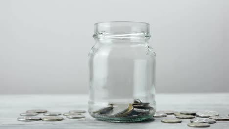 Coins-falling-into-the-jar.-Savings-in-the-jar