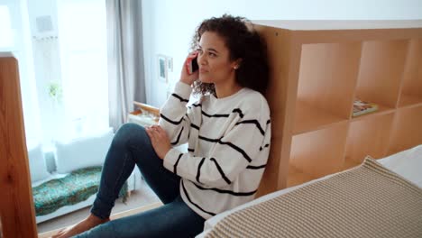 Charming-young-woman-using-phone-at-modern-stylish-apartment.