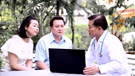 Doctor-and-patient-discussing-medical-examination-outdoor-in-garden.