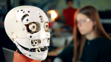 Robotic-head-opens-its-mouth-under-supervision-of-a-female-expert