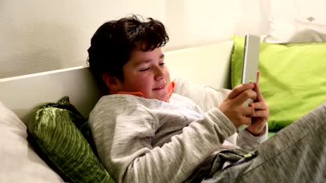 Child-playing-computer-game-on-digital-tablet-in-the-home