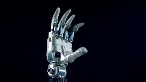 A-robotic-hand-works,-moving-fingers,-close-up.