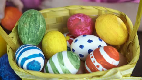 A-child-puts-Easter-eggs-in-a-basket.