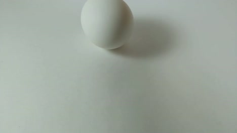 Egg-spinning-and-rolling-on-the-white-table-Easter-egg