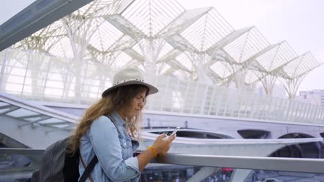 Woman-standing-on-entrance-in-transportation-terminal