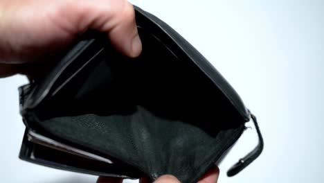 Man-bankrupt-arrears-shows-empty-wallet-with-no-money-on-white-background