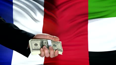 France-and-UAE-officials-exchanging-tank-money,-flag-background,-military-forces