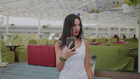 Beautiful-woman-making-selfie-on-the-veranda-of-the-restaurant